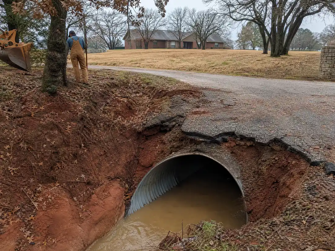 Acreage driveway crossing a culvert over a roadside ditch in Choctaw, Oklahoma