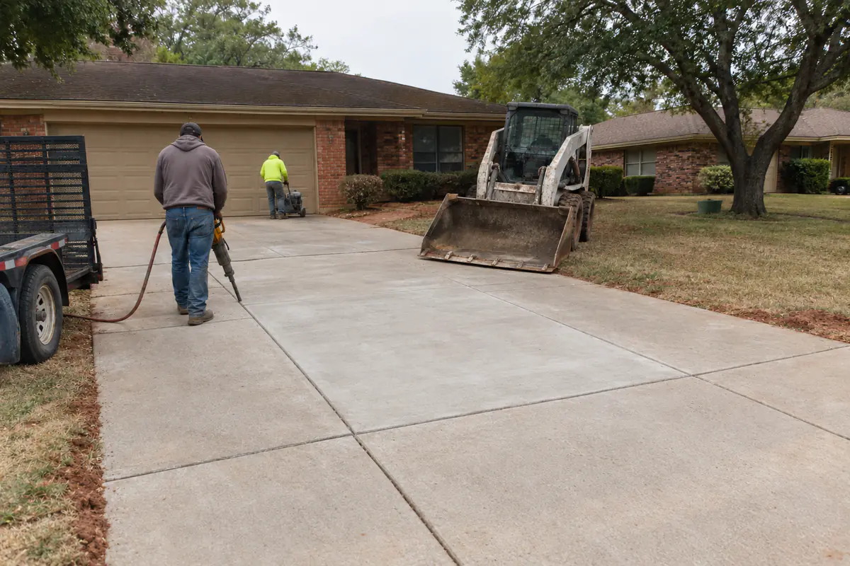 After: the shattered sunken panel replaced with a new flush concrete panel, slightly lighter in color, joints sealed