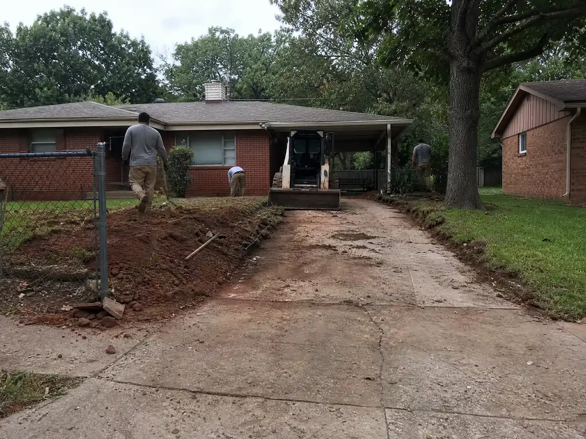 Narrow single-car 1950s concrete driveway at a small brick home in Midwest City, Oklahoma