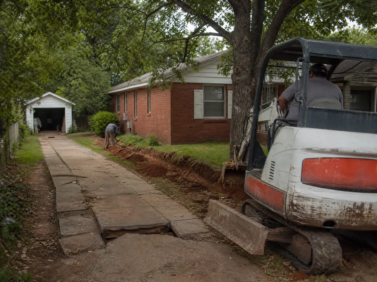 Cracked concrete driveway at a 1940s brick cottage in Bethany, Oklahoma