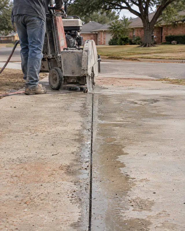 Saw-cut line across the driveway before apron removal in Oklahoma City